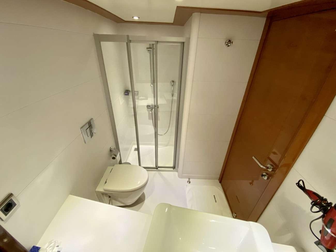 a bathroom with a shower and toilet aboard CANARIA Yacht for Charter