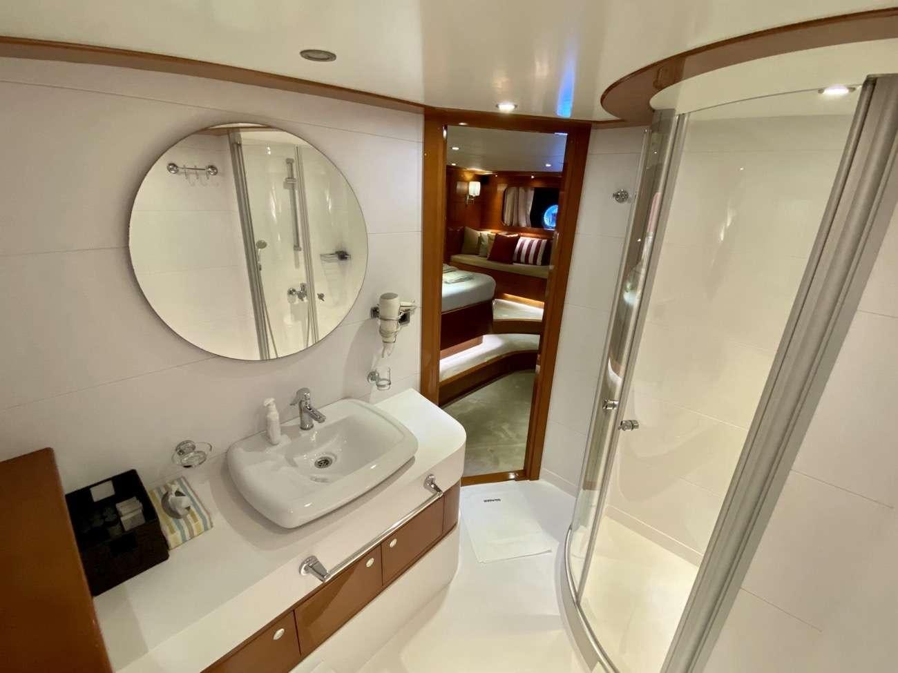 a bathroom with a large mirror aboard CANARIA Yacht for Charter