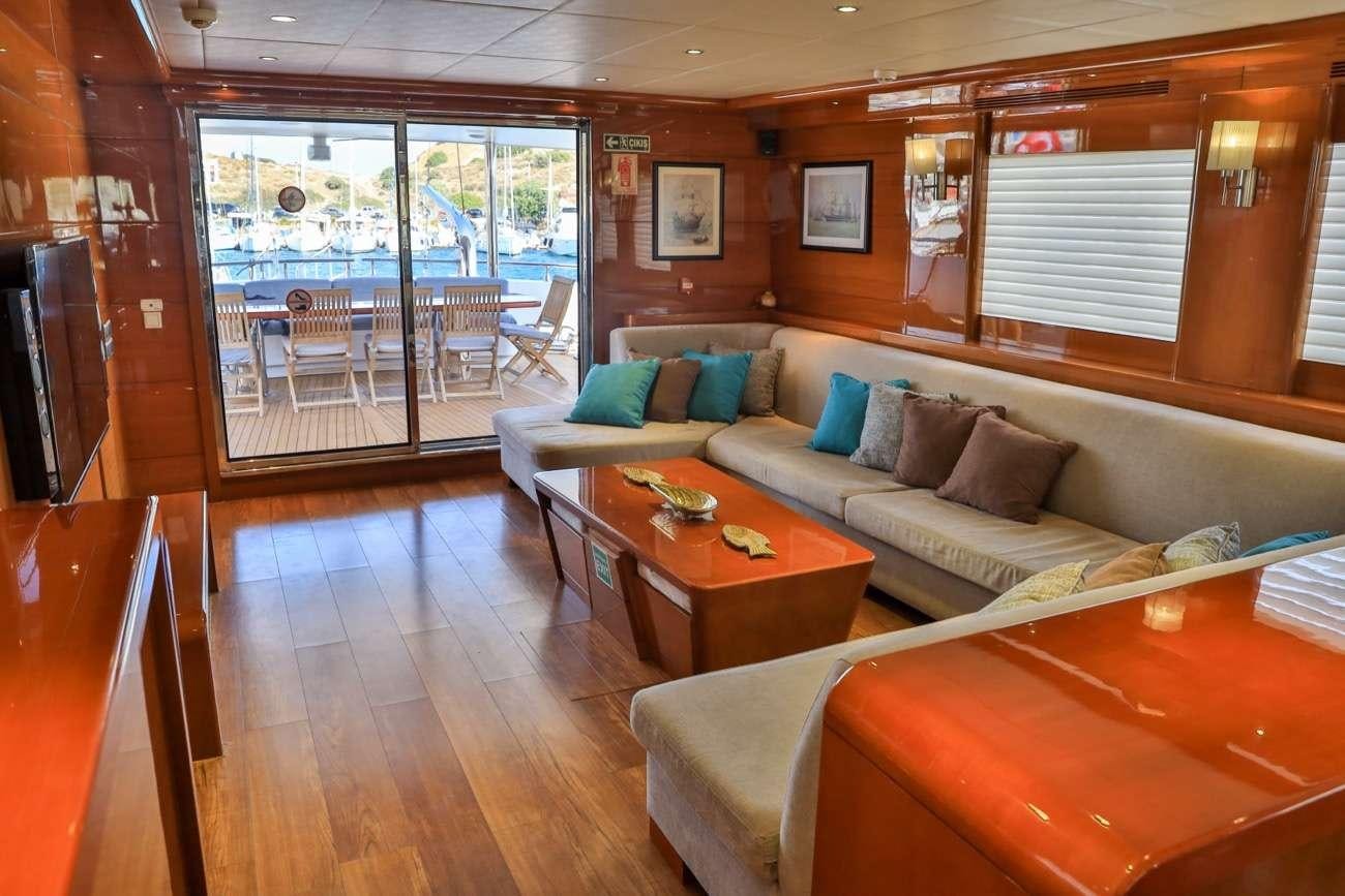 a living room with a couch and a table aboard CANARIA Yacht for Charter