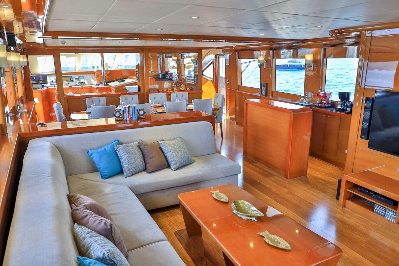 a living room with a couch and a table aboard CANARIA Yacht for Charter