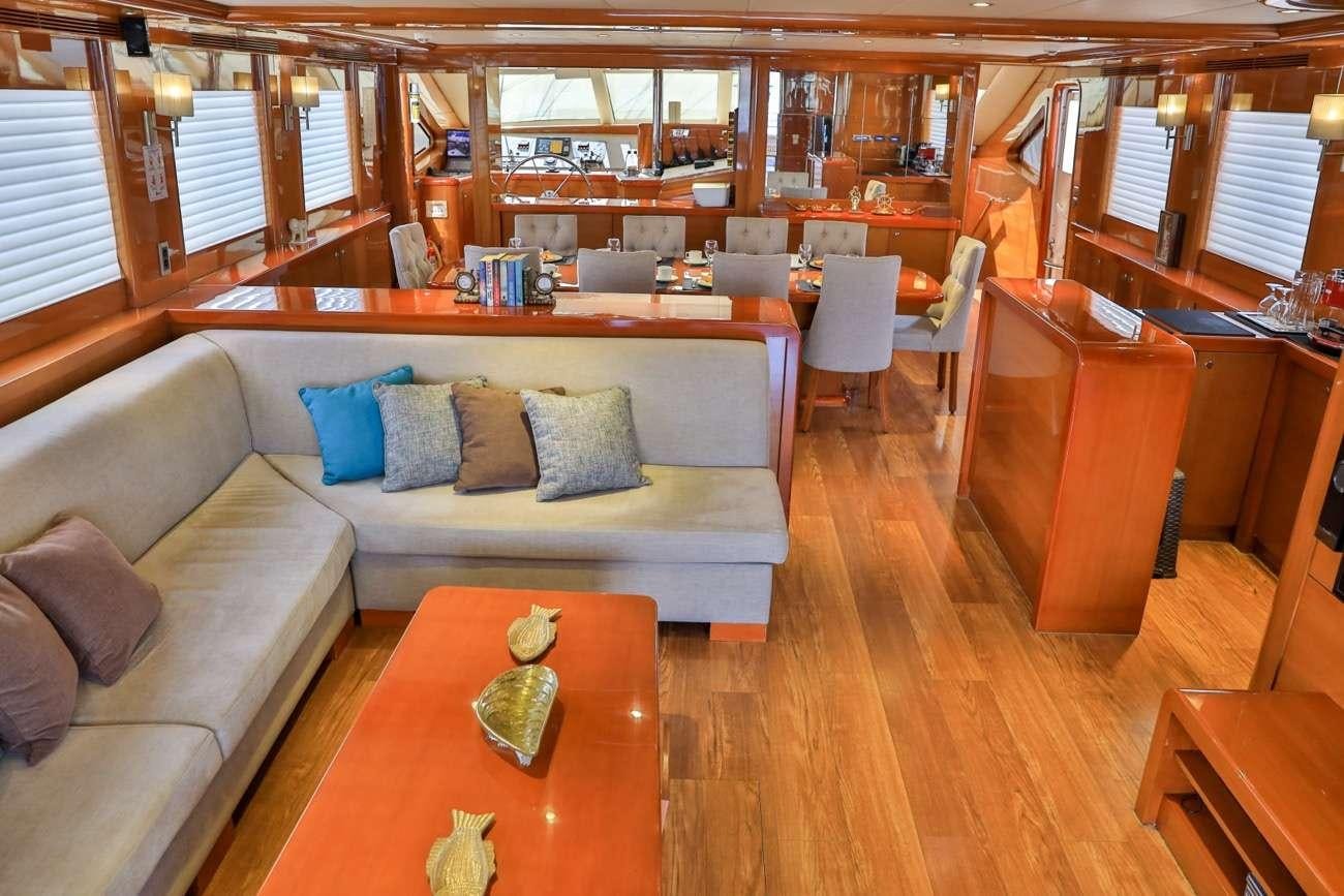 a living room with a couch and a table aboard CANARIA Yacht for Charter