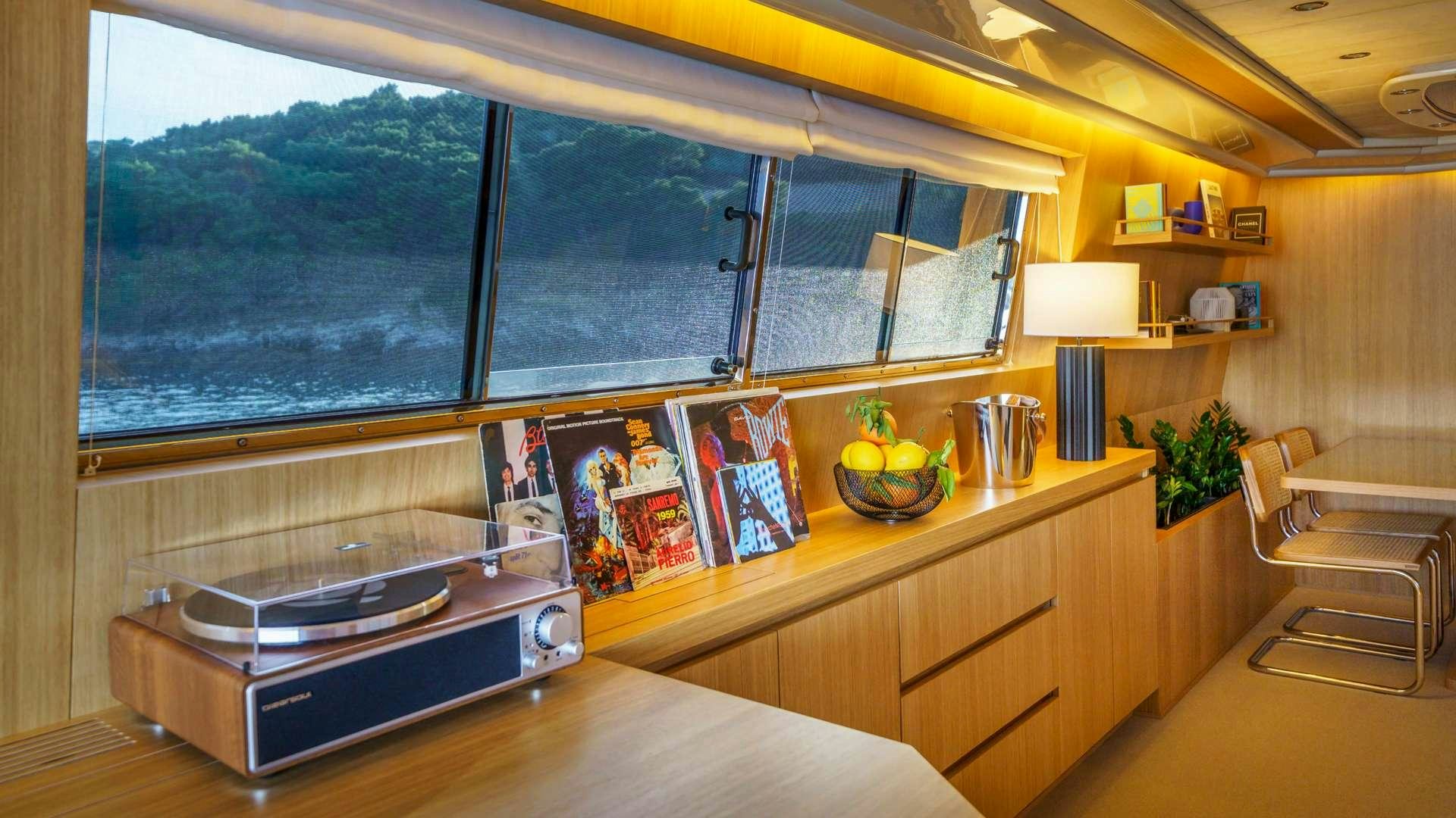 a room with a table and a window aboard PHANTOM Yacht for Charter