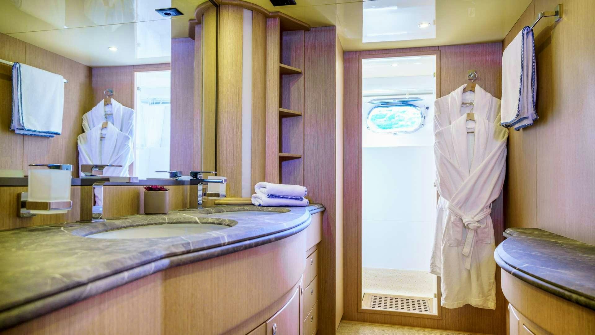 a bathroom with a countertop sink and cabinets aboard PHANTOM Yacht for Charter