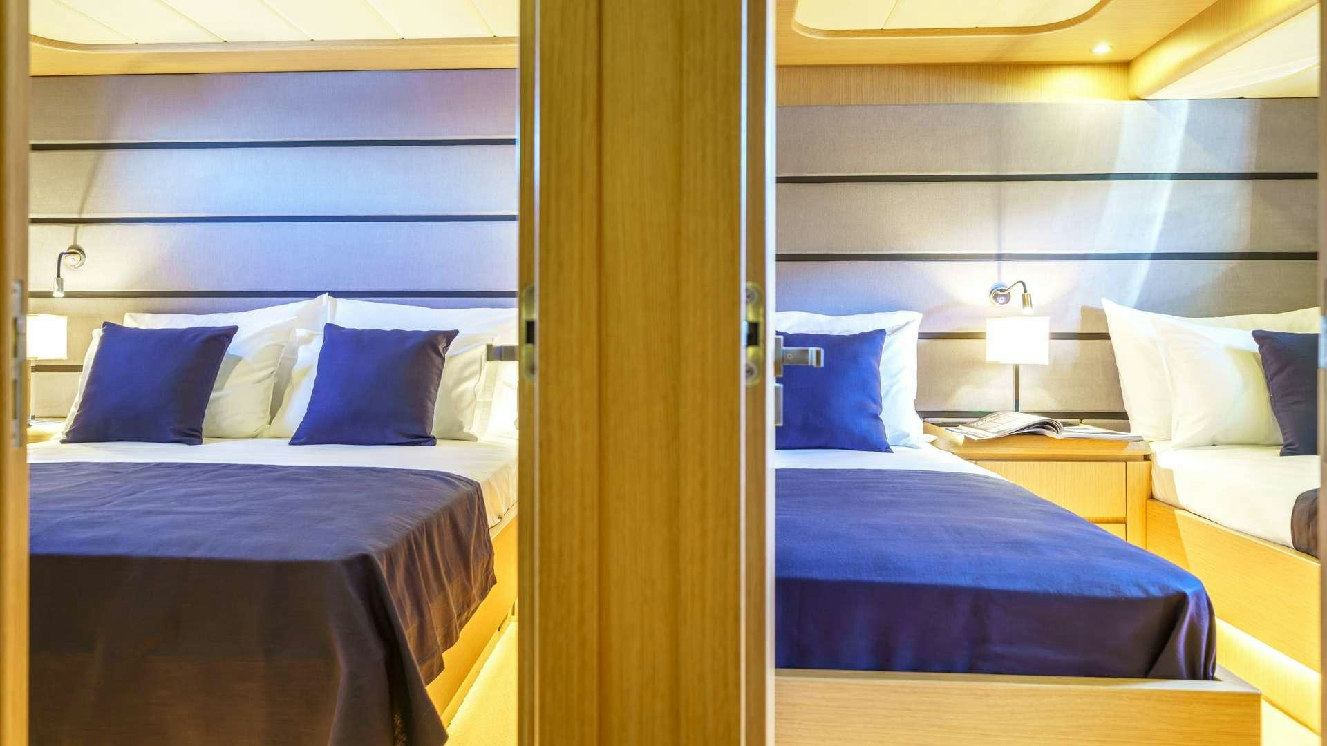 a room with a bed and a lamp aboard PHANTOM Yacht for Charter