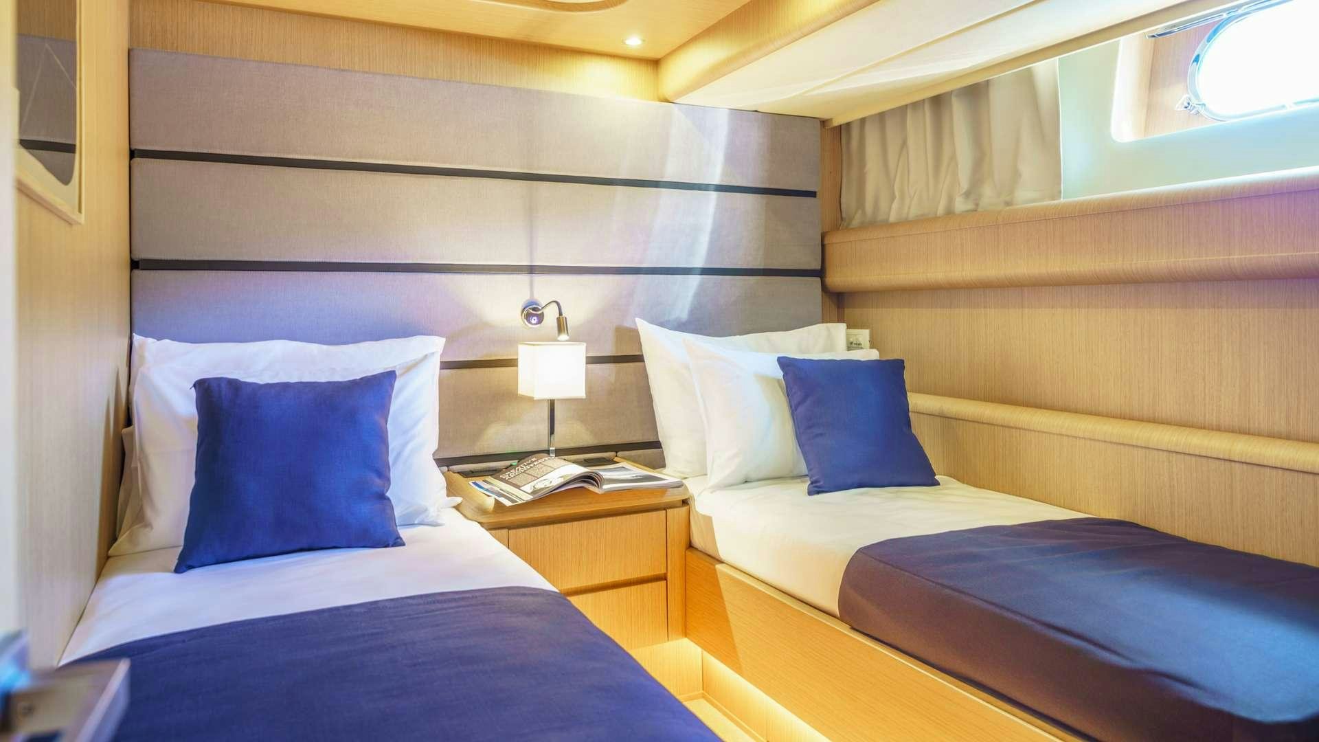 a room with two beds aboard PHANTOM Yacht for Charter