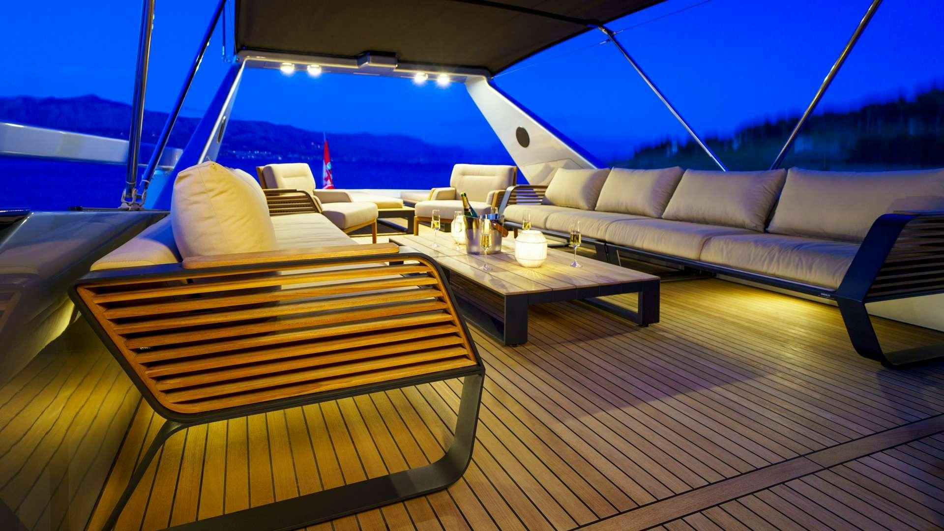 a deck with a table and chairs aboard PHANTOM Yacht for Charter