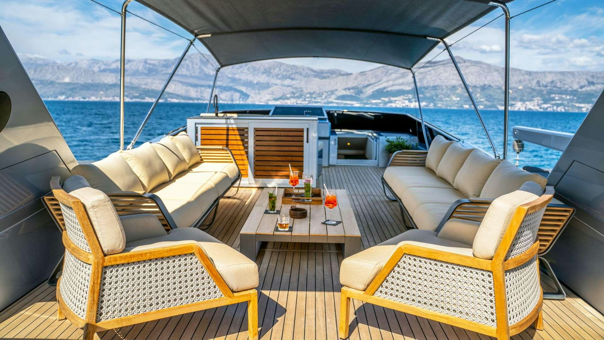 a boat with a table and chairs aboard PHANTOM Yacht for Charter