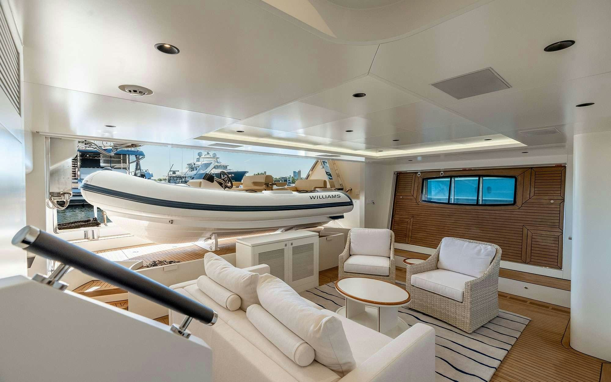 a room with a large bed and a table with chairs aboard MISS MICHELLE Yacht for Charter