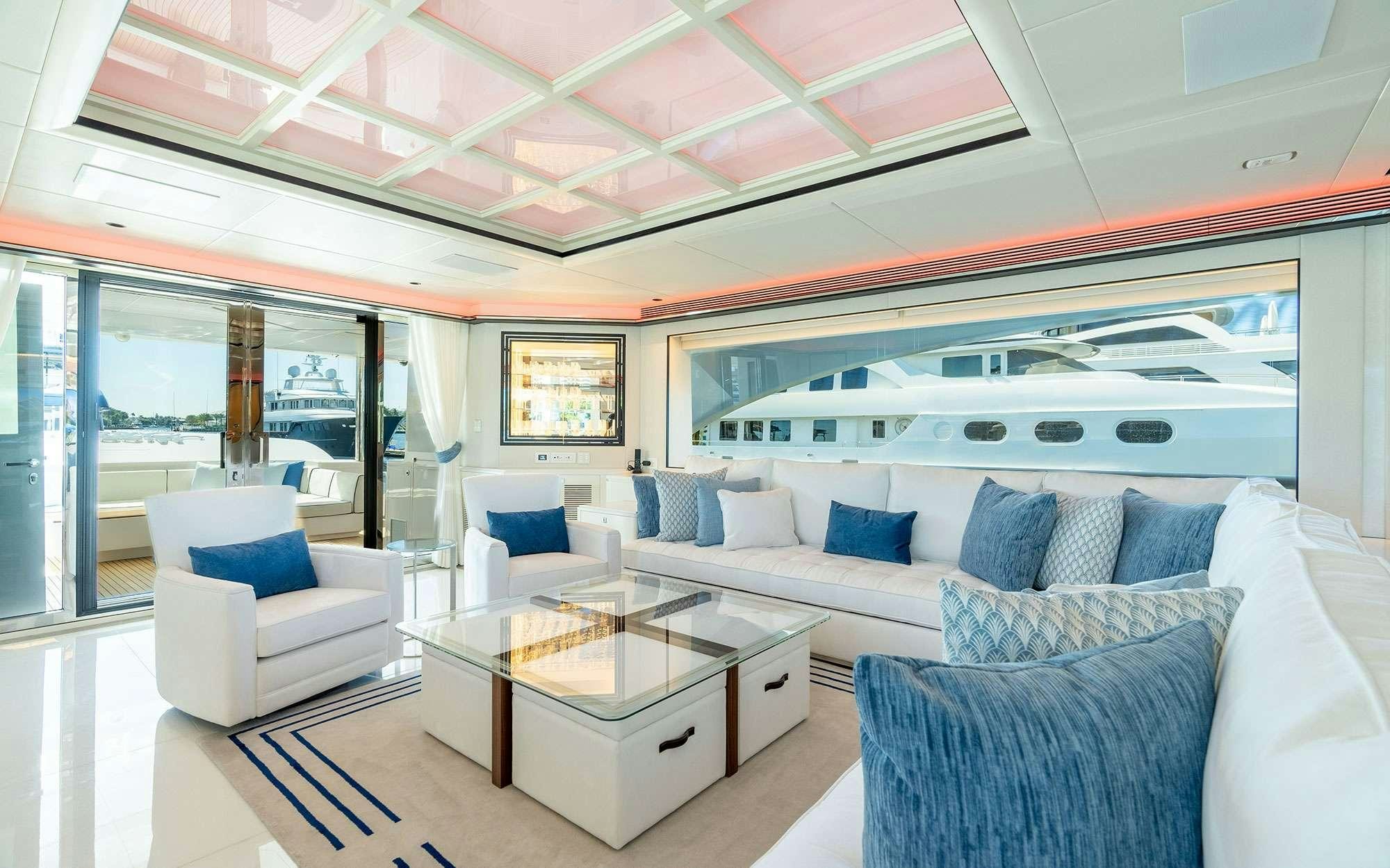 a living room with a large window aboard MISS MICHELLE Yacht for Charter