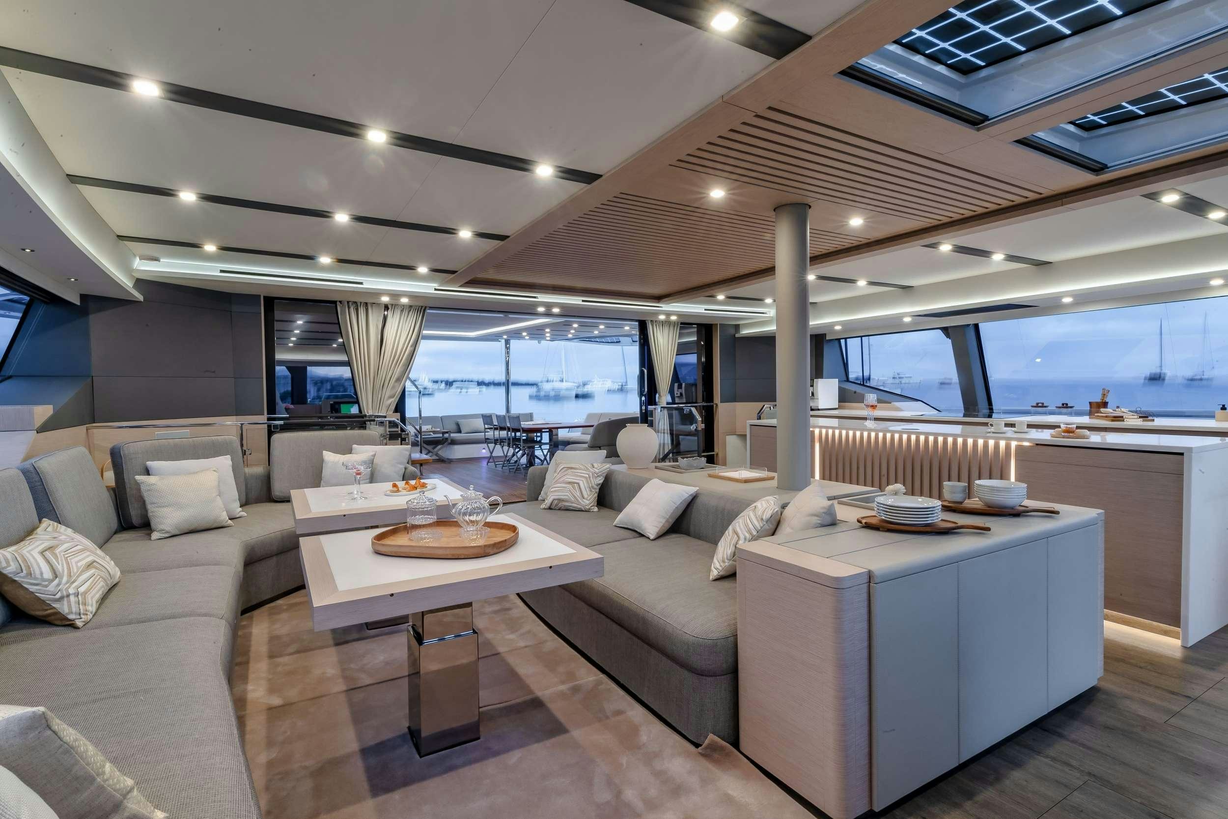 a living room with a large window aboard CHRISTAL MIO 80 Yacht for Charter