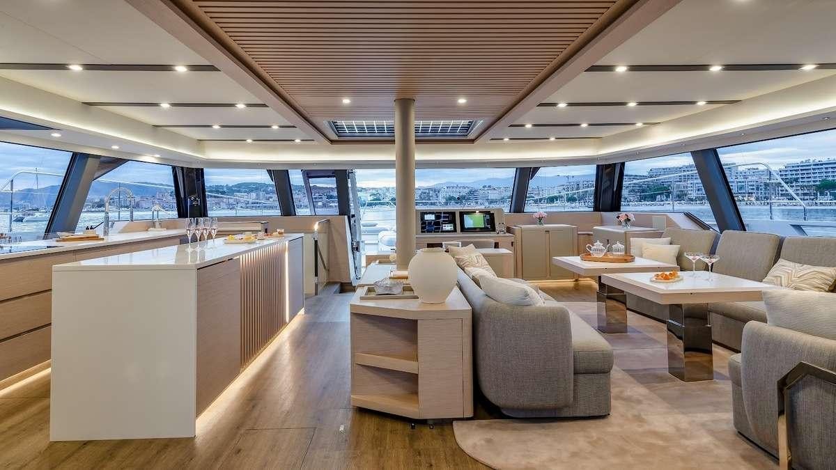 a room with a table chairs and a large window aboard CHRISTAL MIO 80 Yacht for Charter