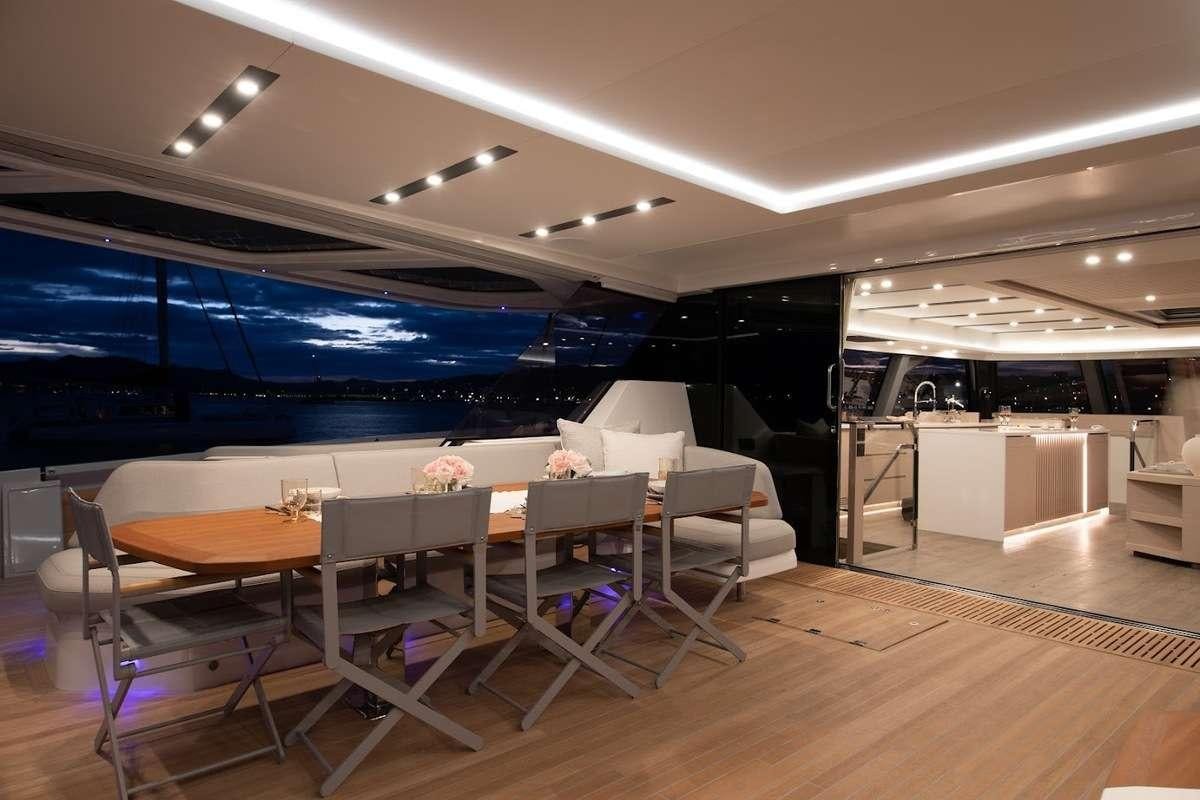 a room with tables and chairs aboard CHRISTAL MIO 80 Yacht for Charter