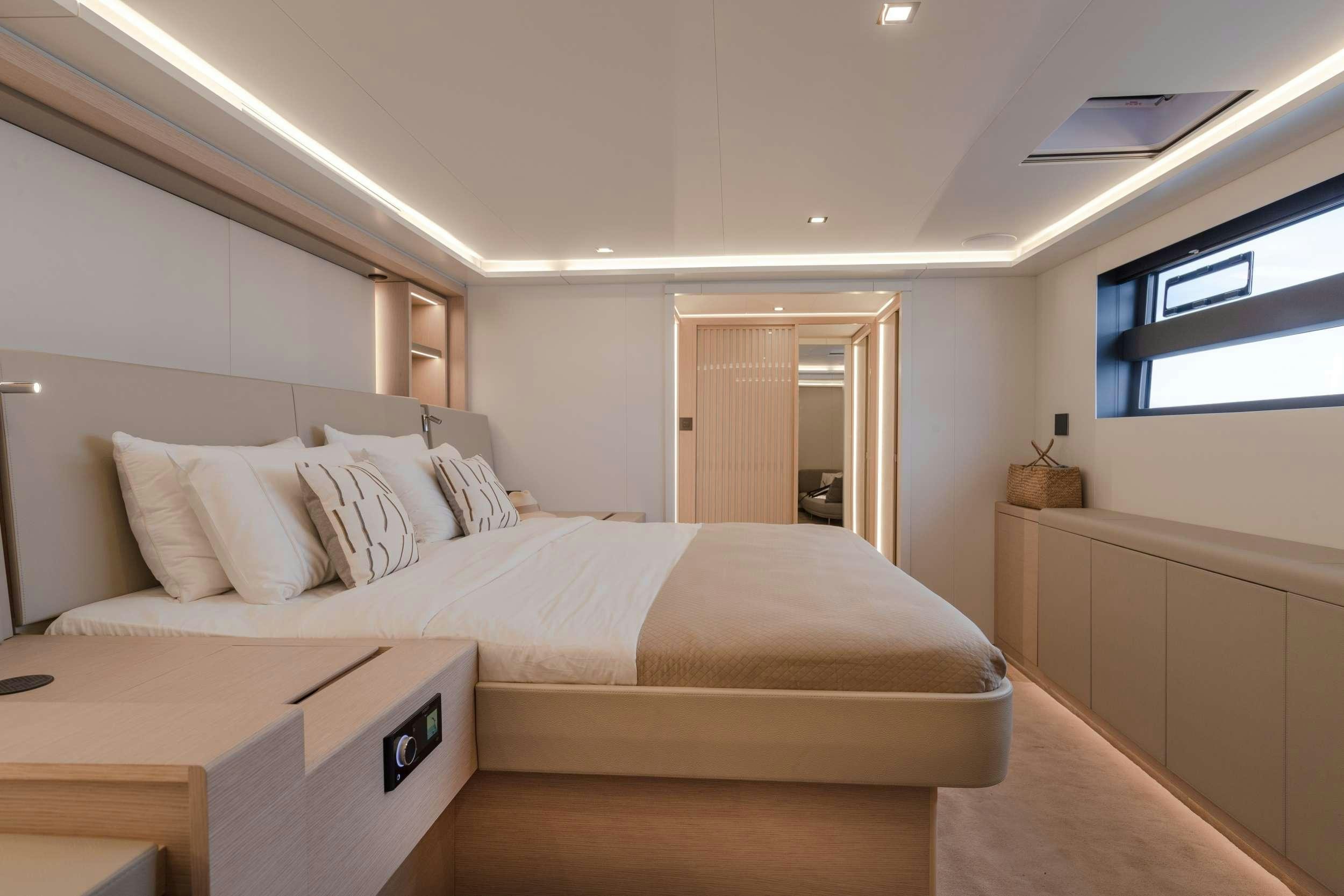 a bedroom with a bed and a desk aboard CHRISTAL MIO 80 Yacht for Charter