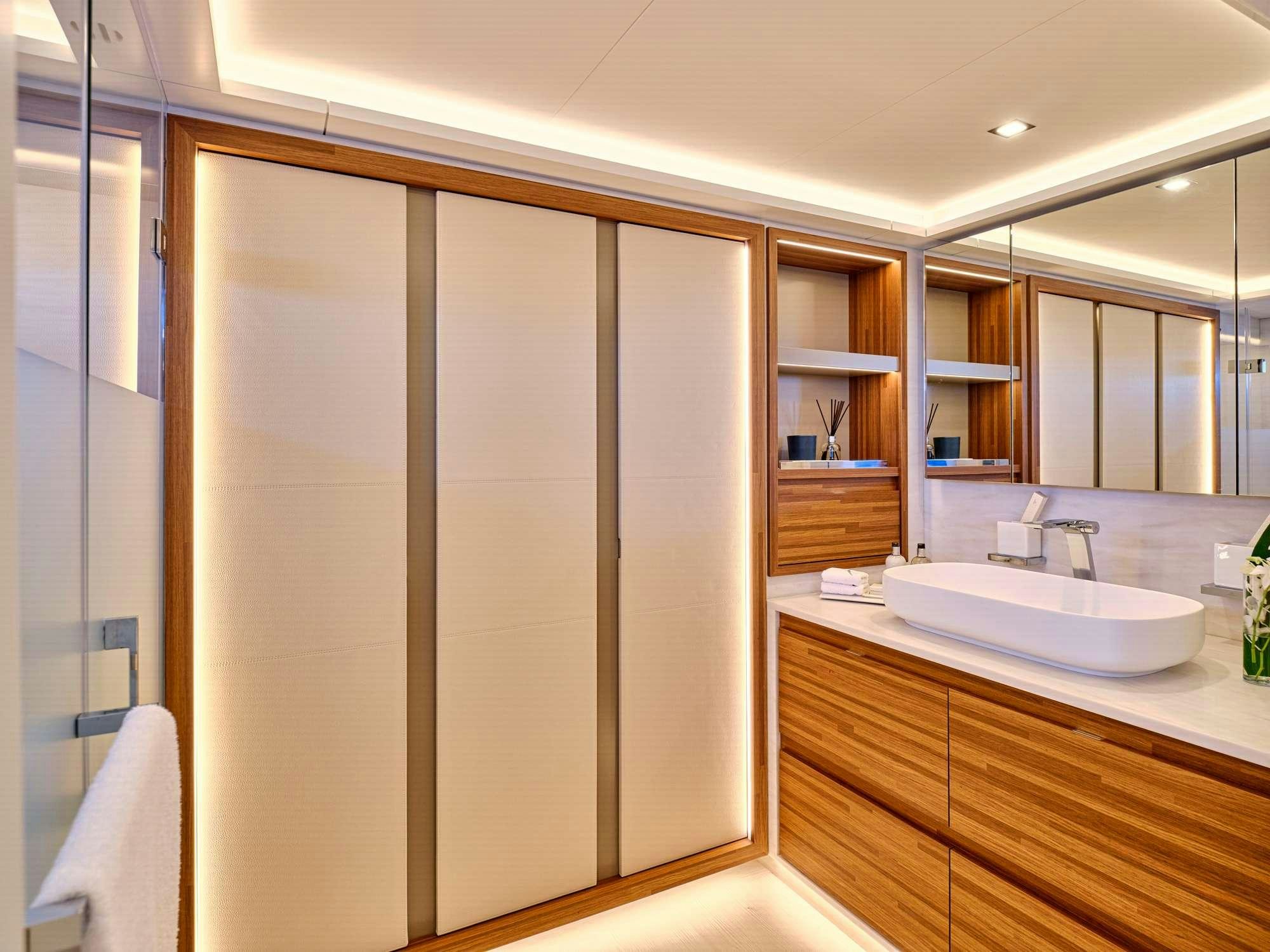 a bathroom with a sink and cabinets aboard CHRISTAL MIO 80 Yacht for Charter