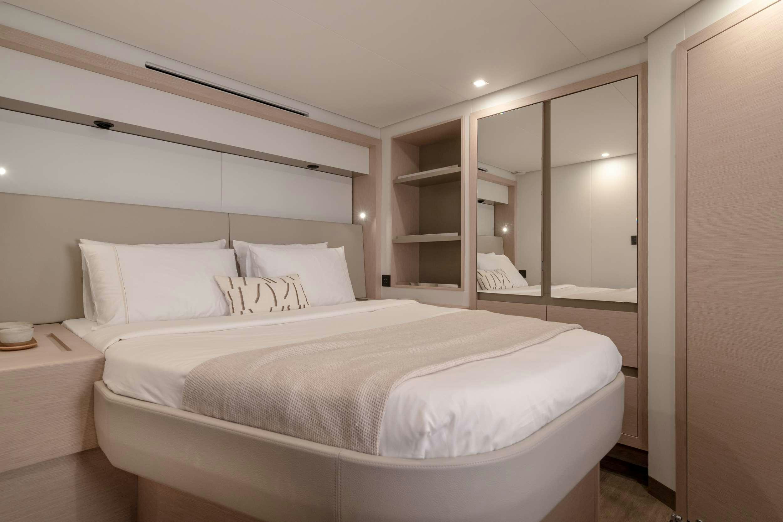a bed with white sheets aboard CHRISTAL MIO 80 Yacht for Charter