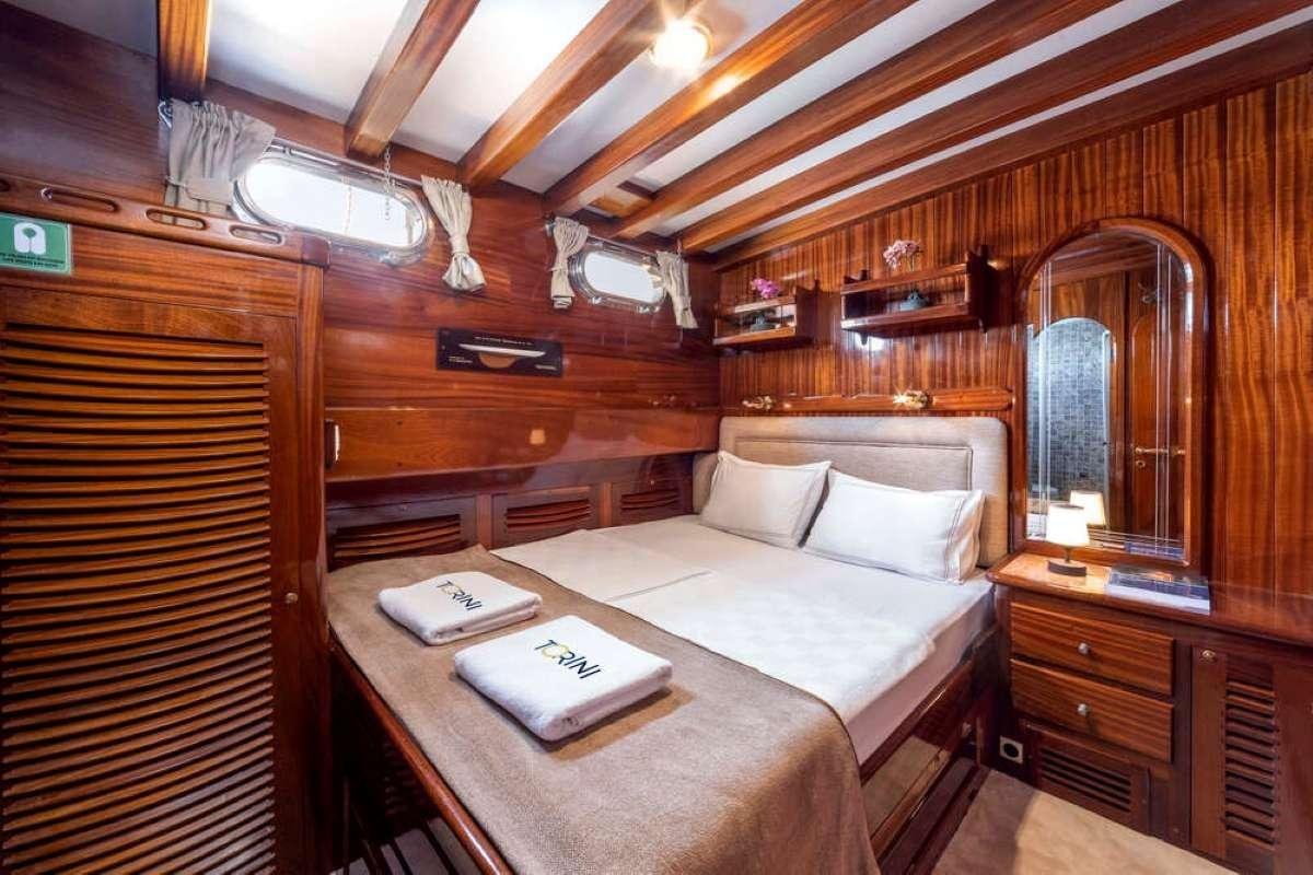 a bed in a cabin aboard TORINI Yacht for Charter