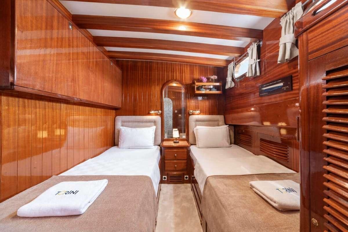a room with a bed and a mirror aboard TORINI Yacht for Charter