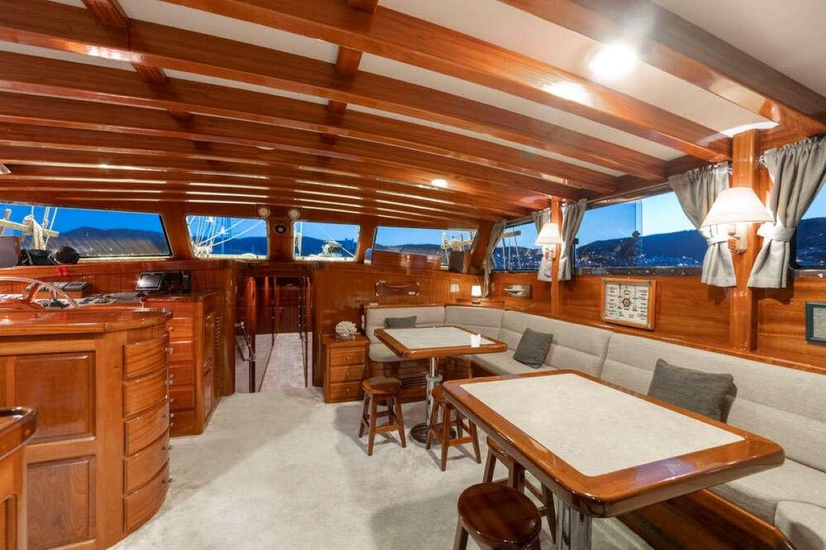 a room with a table and chairs aboard TORINI Yacht for Charter