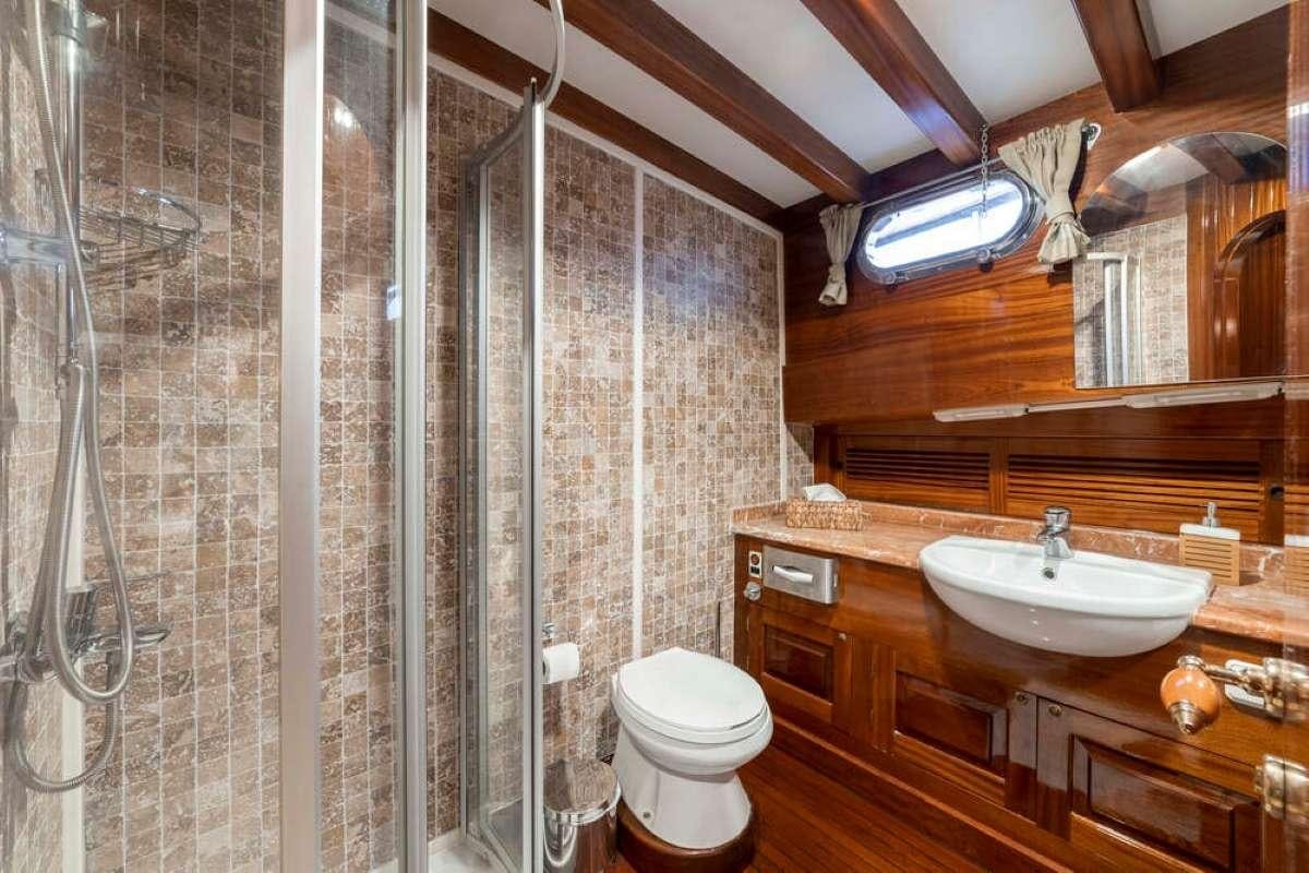 a bathroom with a shower and sink aboard TORINI Yacht for Charter