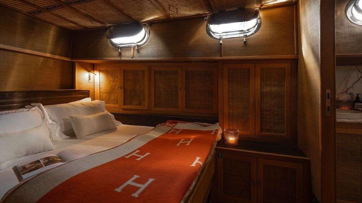 a bed in a room aboard MY LOVER Yacht for Charter