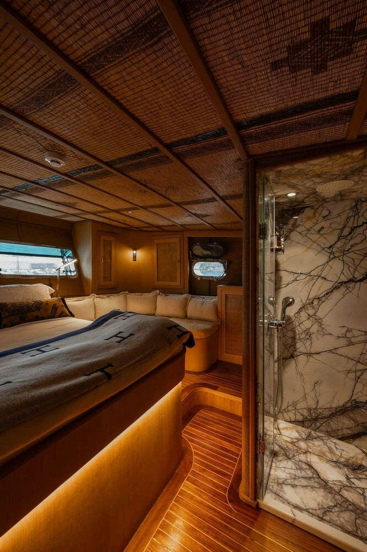a bedroom with a glass door aboard MY LOVER Yacht for Charter