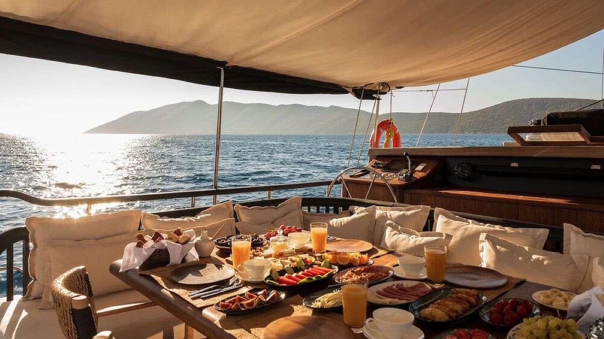 a table with food on it aboard MY LOVER Yacht for Charter