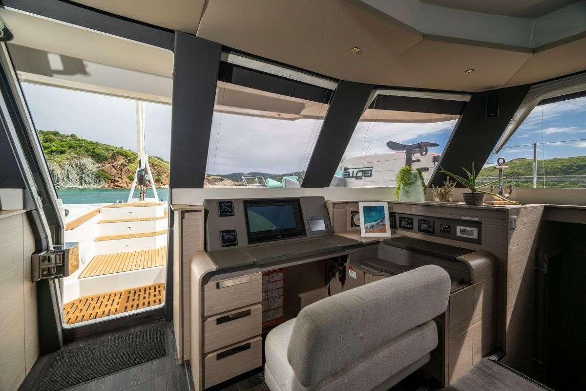 a car with a desk and computer aboard LYRA Yacht for Charter