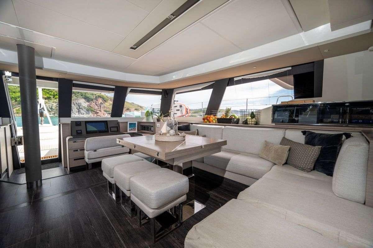 a living room with a large window aboard LYRA Yacht for Charter