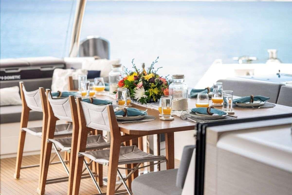 a table set for a meal on a boat aboard LYRA Yacht for Charter