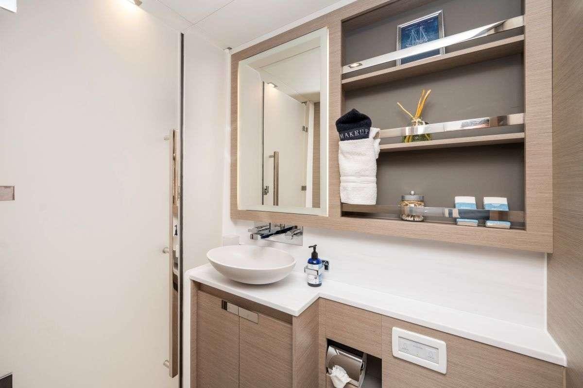 a bathroom with a sink and a mirror aboard LYRA Yacht for Charter