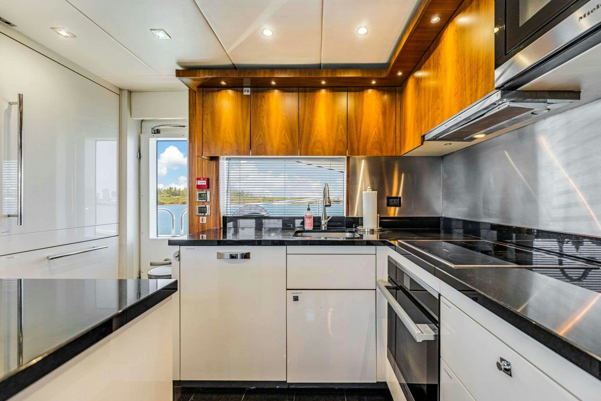 a kitchen with white cabinets aboard RMM JOB Yacht for Charter