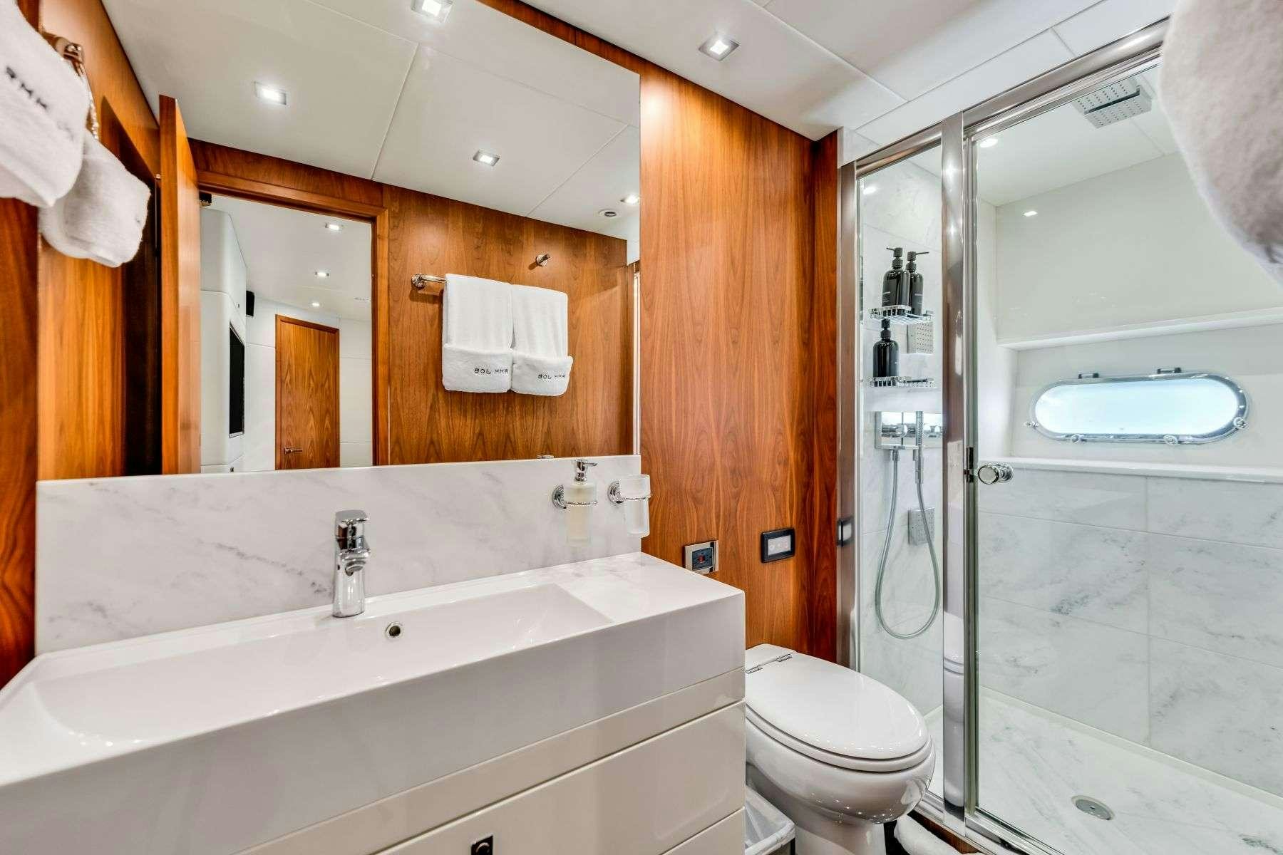 a bathroom with a glass shower aboard RMM JOB Yacht for Charter