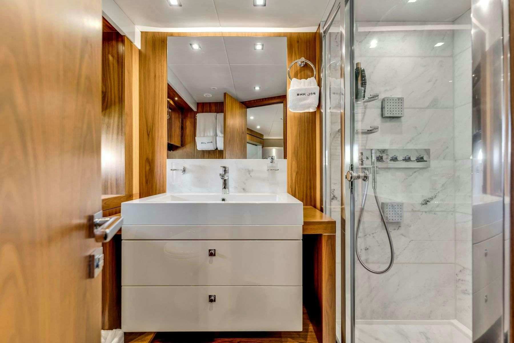 a bathroom with a sink and shower aboard RMM JOB Yacht for Charter