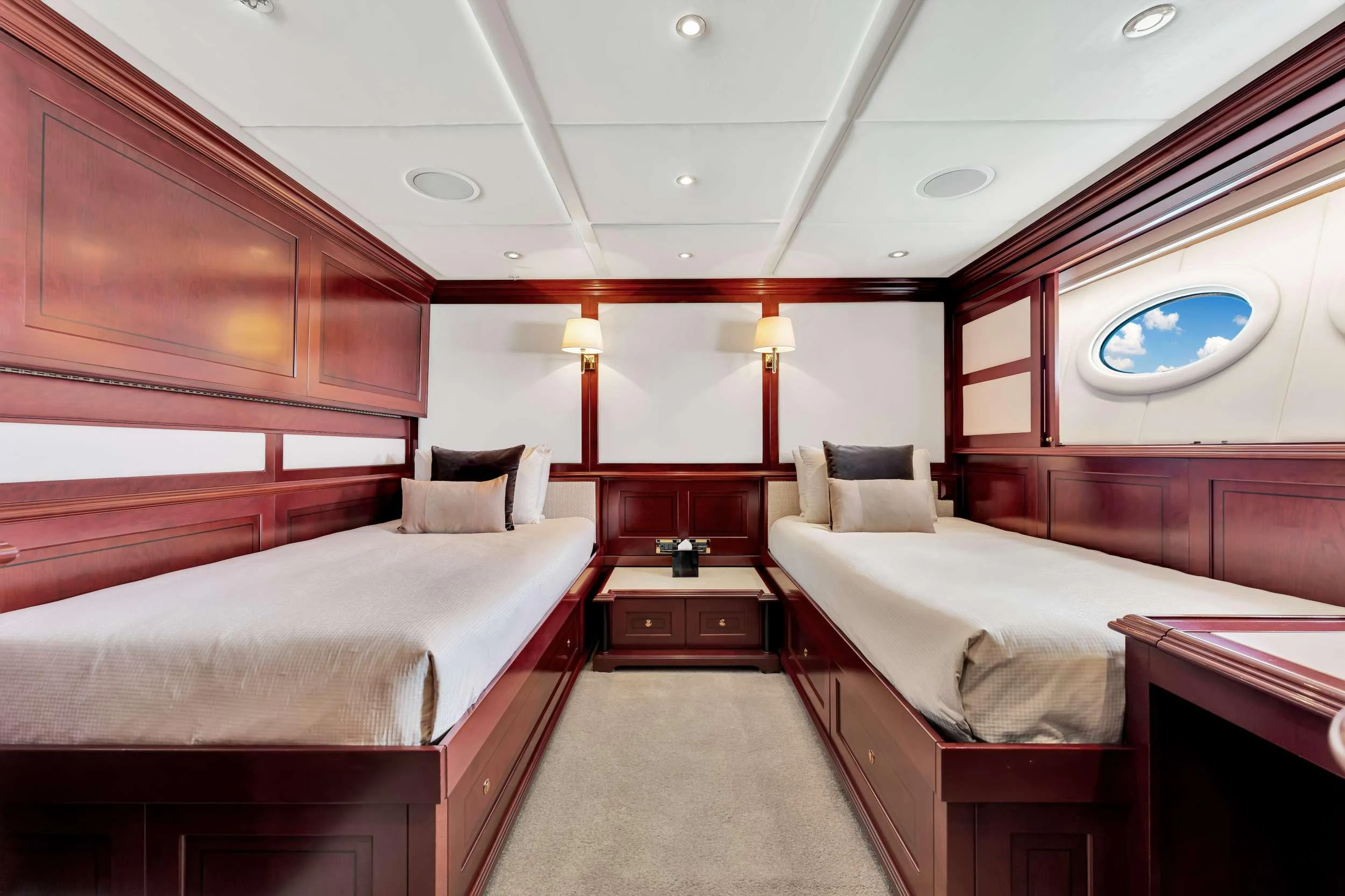 a room with beds and a window aboard SWEET CAROLINE II Yacht for Charter