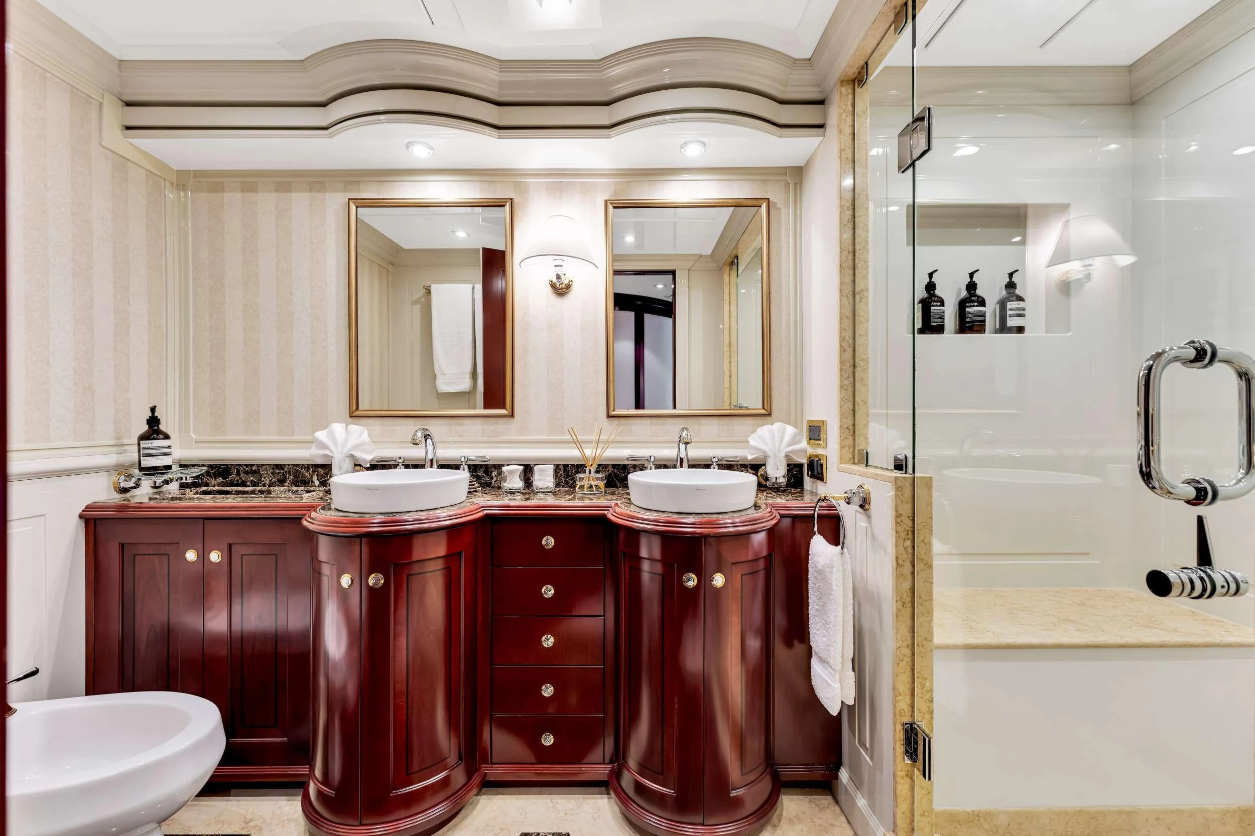 a bathroom with red cabinets aboard SWEET CAROLINE II Yacht for Charter