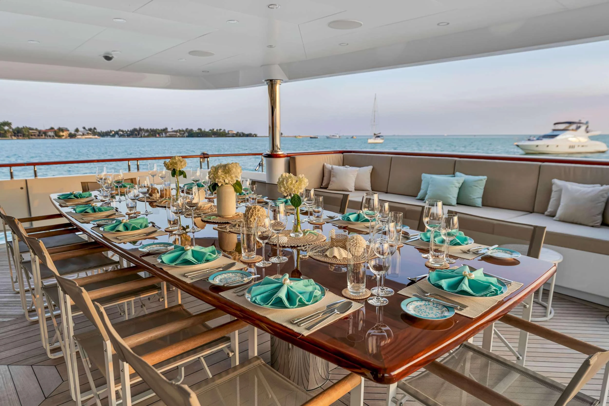 a table with plates and glasses on it aboard SWEET CAROLINE II Yacht for Charter