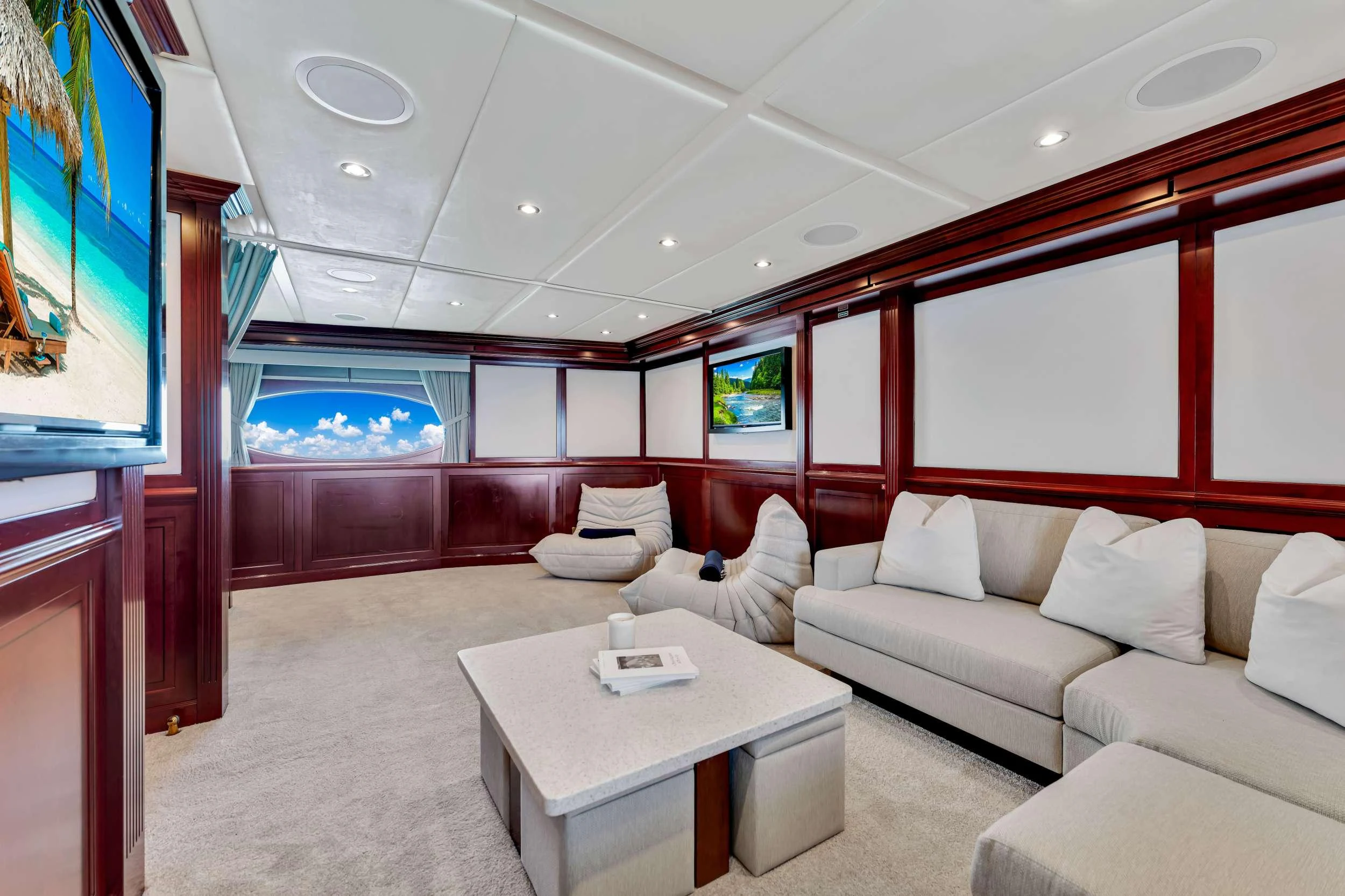 a living room with a large window aboard SWEET CAROLINE II Yacht for Charter