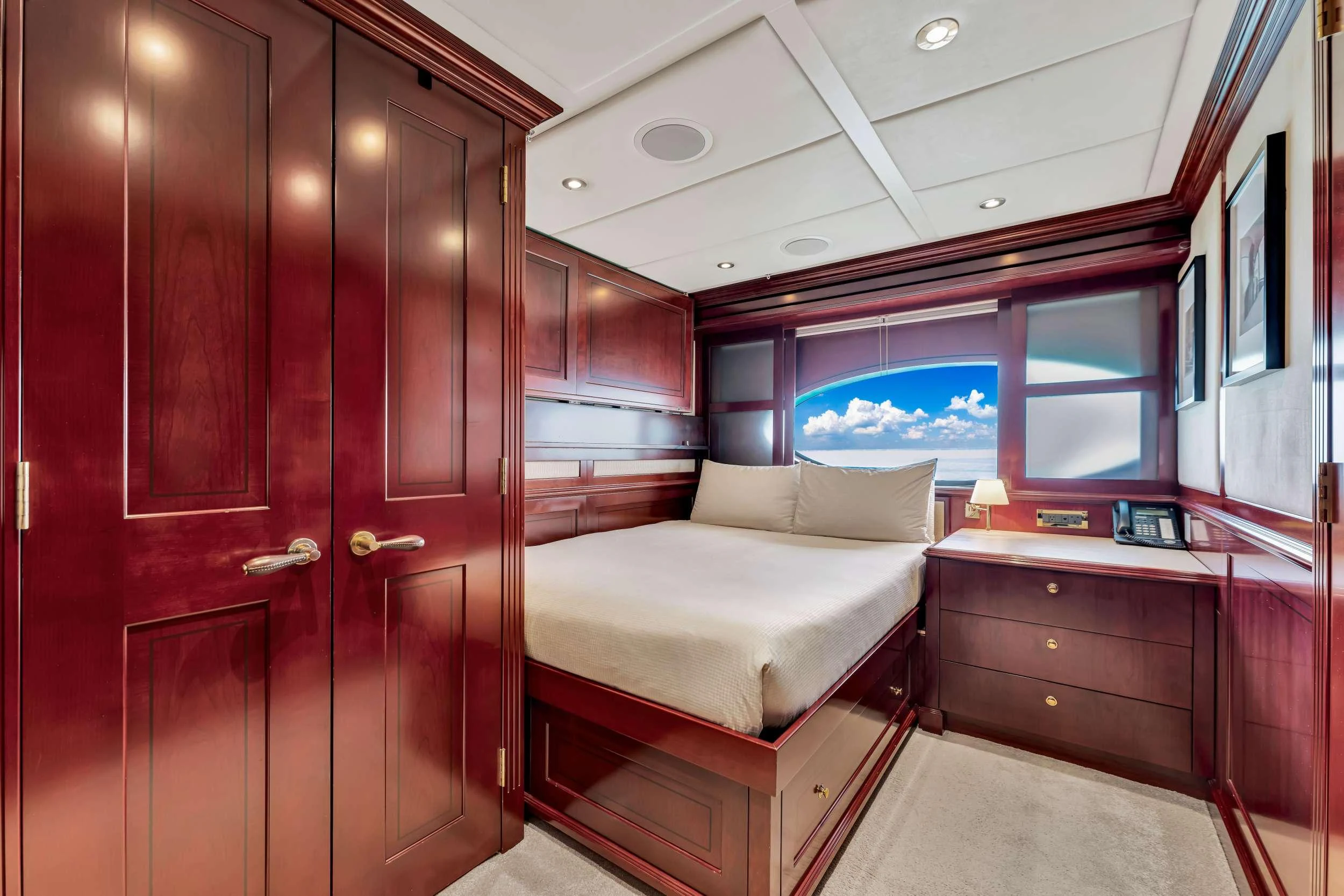 a room with a bed and a desk aboard SWEET CAROLINE II Yacht for Charter