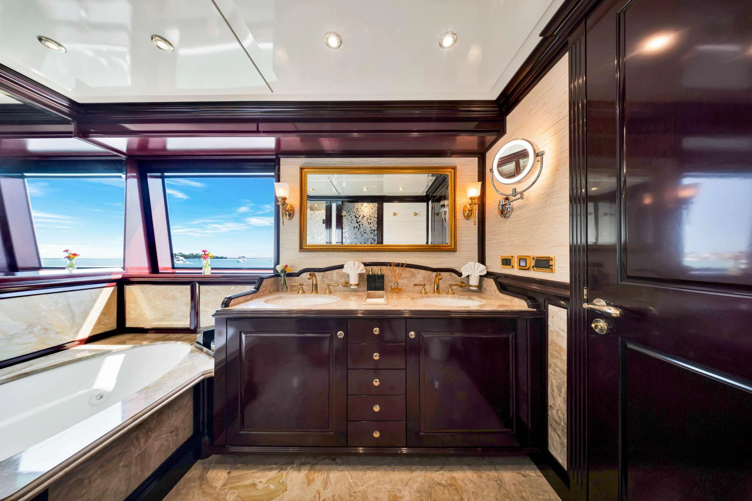 a bathroom with a sink and a large mirror aboard SWEET CAROLINE II Yacht for Charter