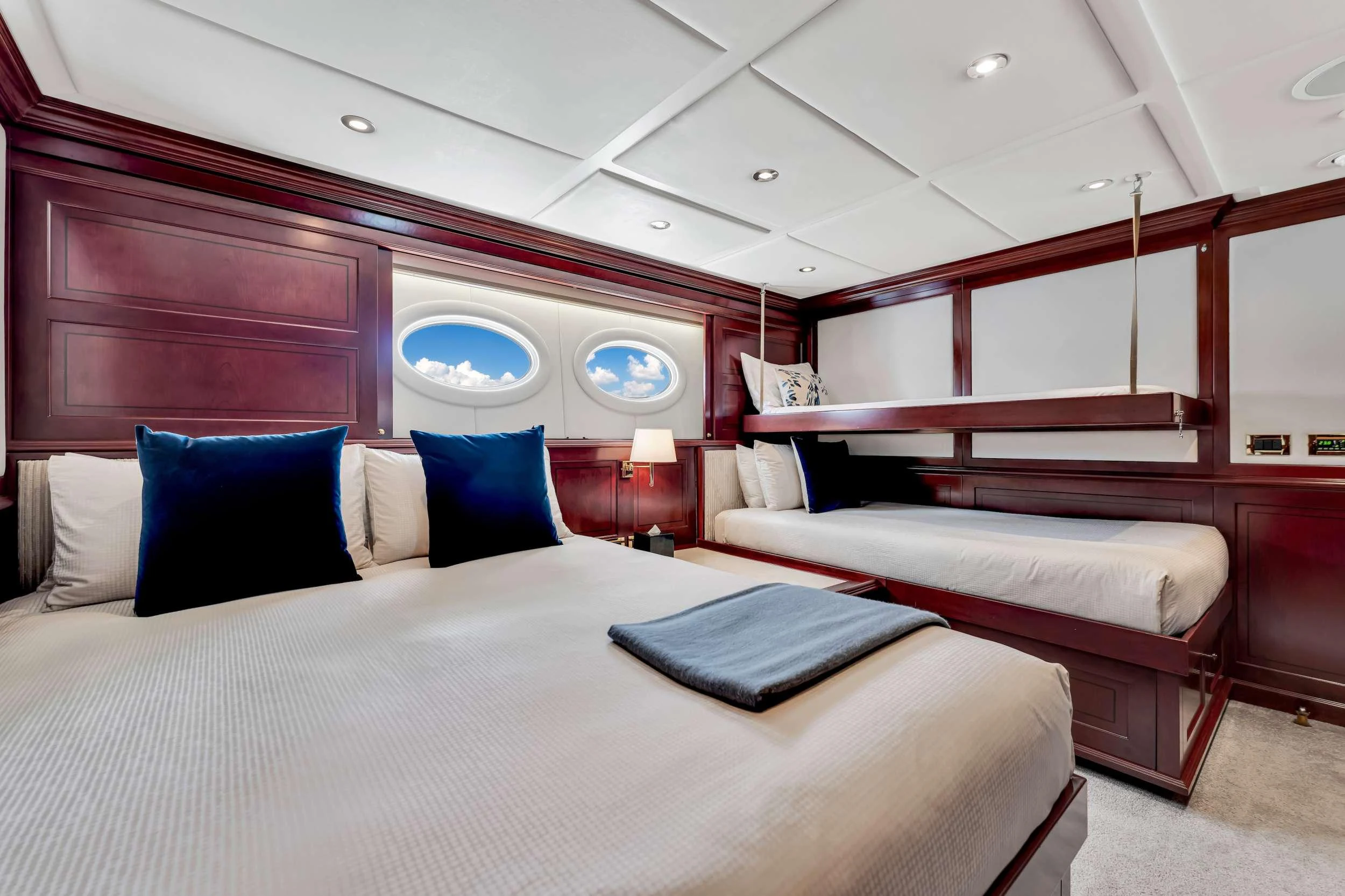 a room with a bed and a window aboard SWEET CAROLINE II Yacht for Charter