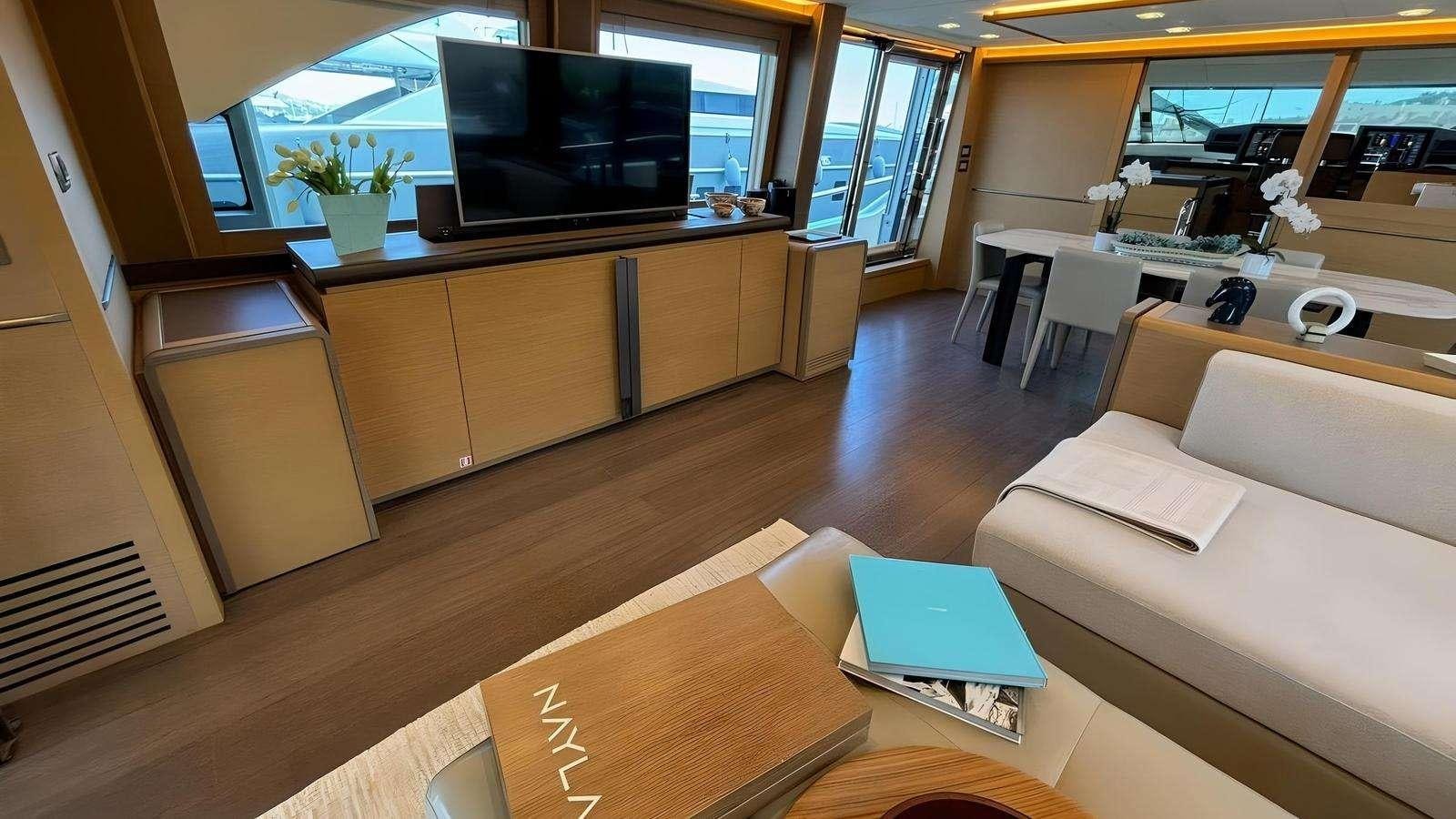 a living room with a tv and furniture aboard NAYLA Yacht for Charter