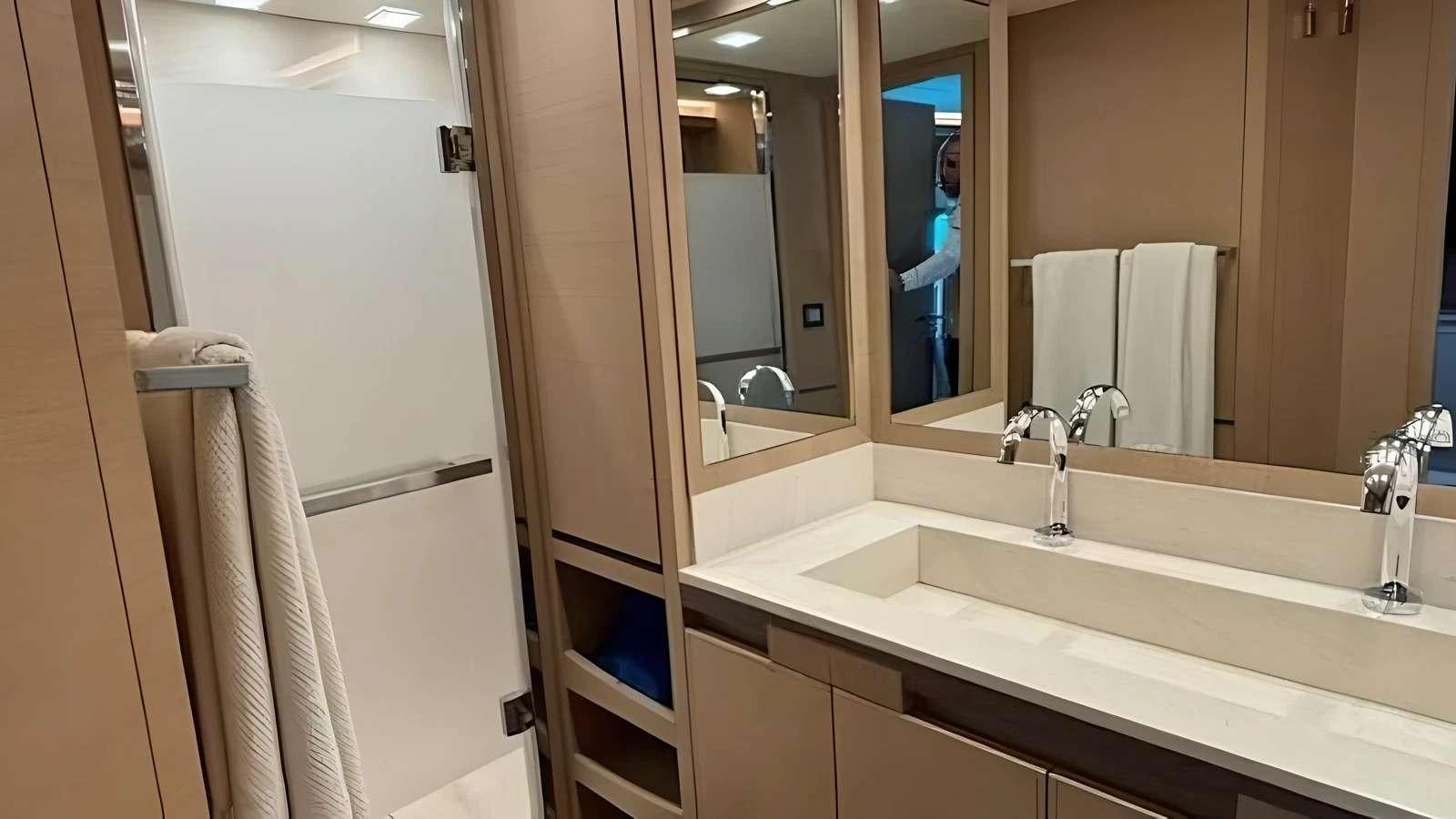 a bathroom with a sink and a mirror aboard NAYLA Yacht for Charter