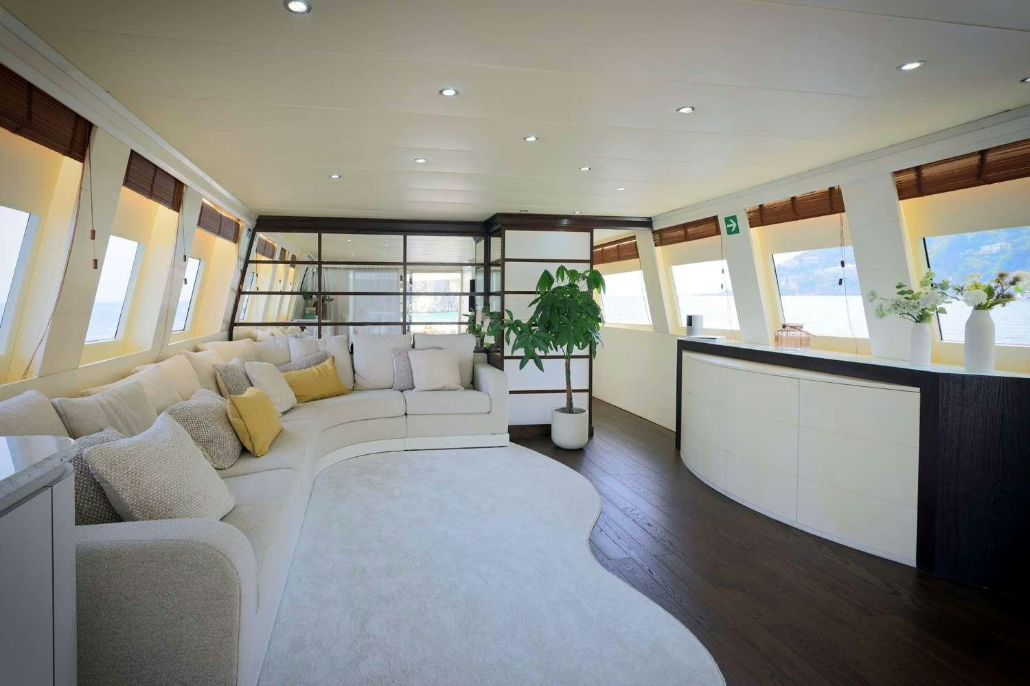 a large room with a couch and a table aboard DEAONE Yacht for Charter