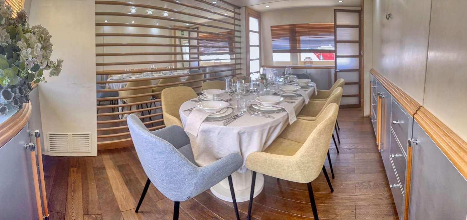 a dining room with a table and chairs aboard DEAONE Yacht for Charter