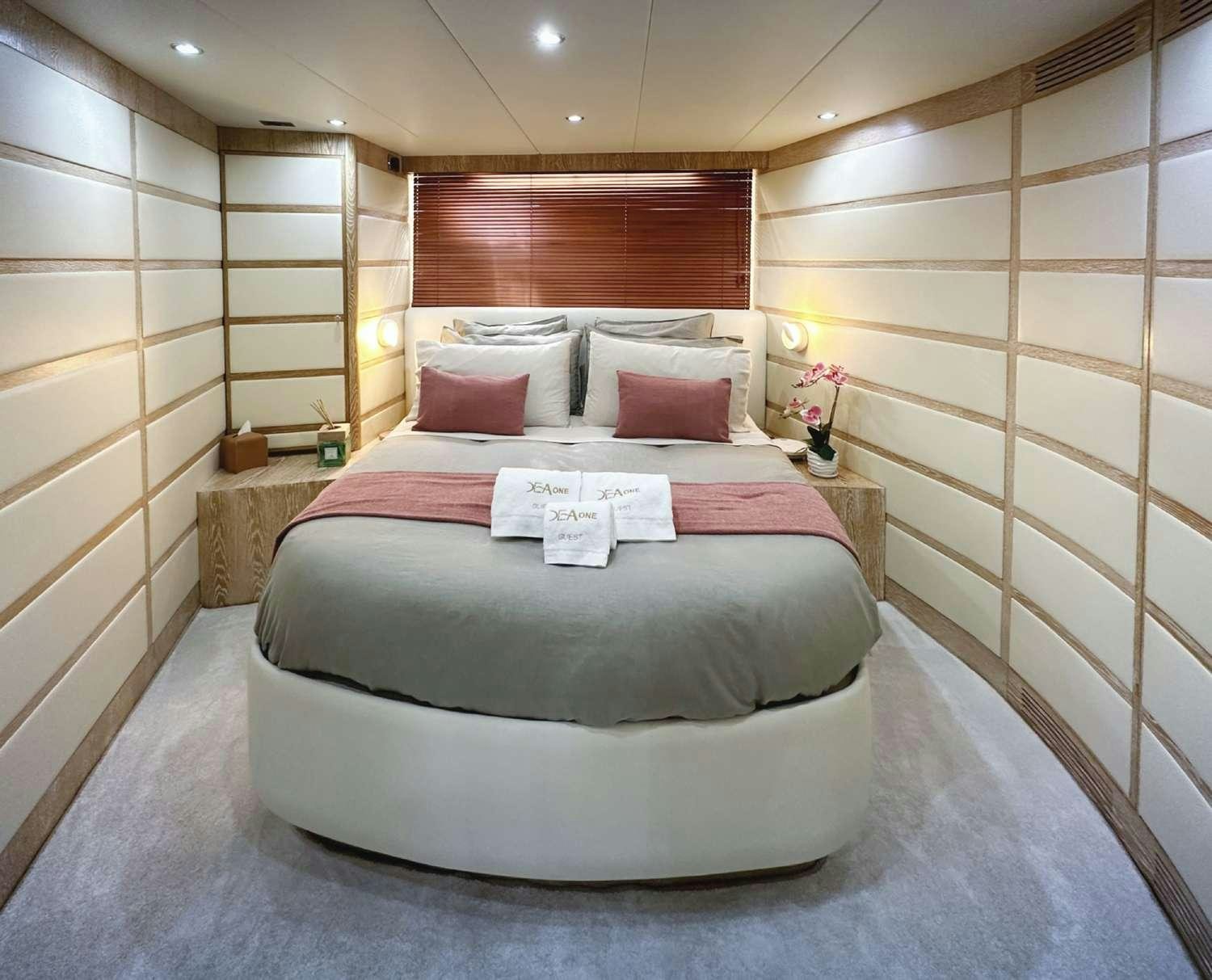 a bed with a white cover aboard DEAONE Yacht for Charter