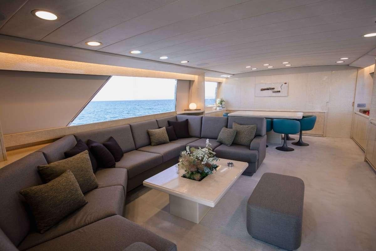a living room with a couch and a table aboard CARI&NTILDE;O Yacht for Charter
