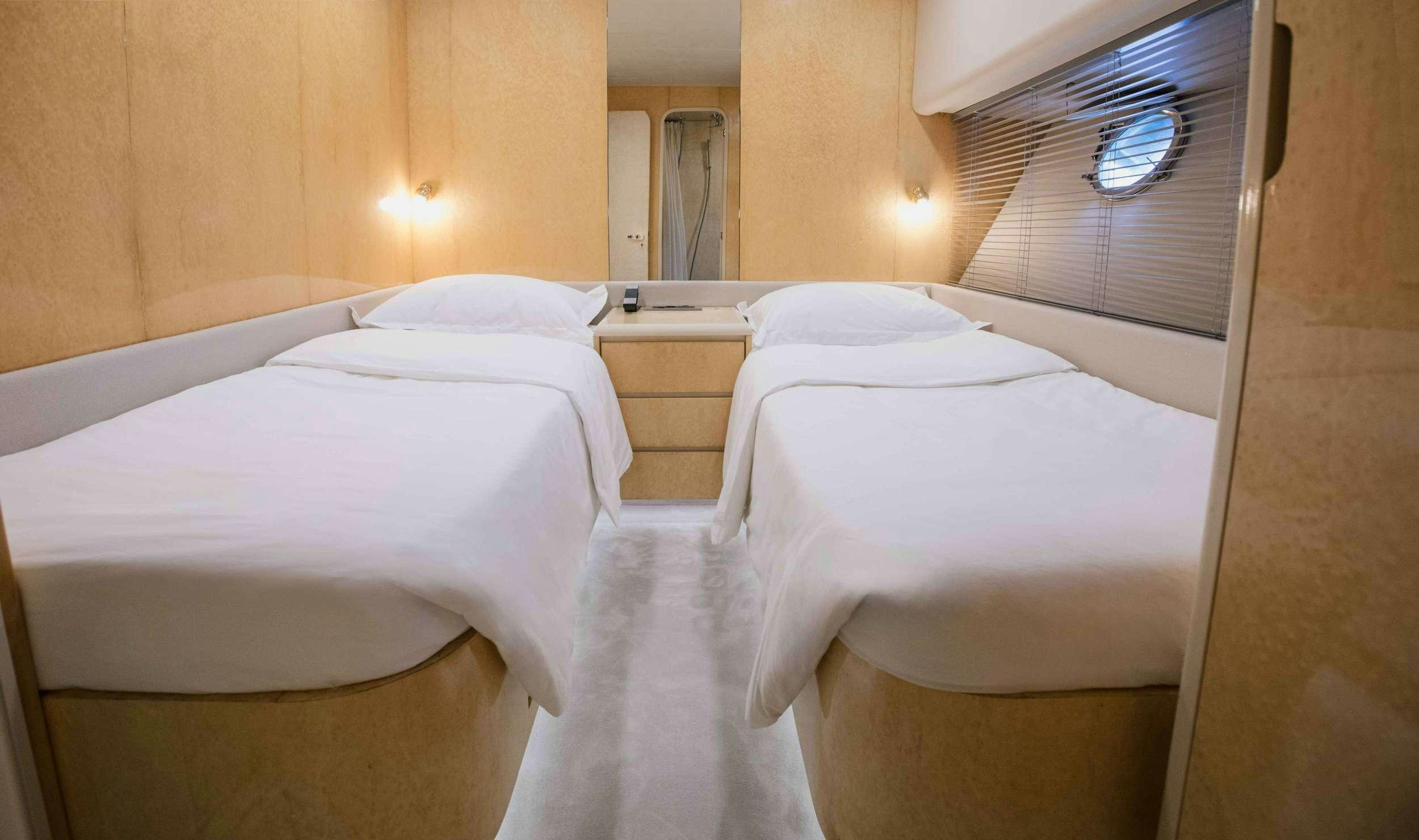 a room with three beds aboard CARI&NTILDE;O Yacht for Charter