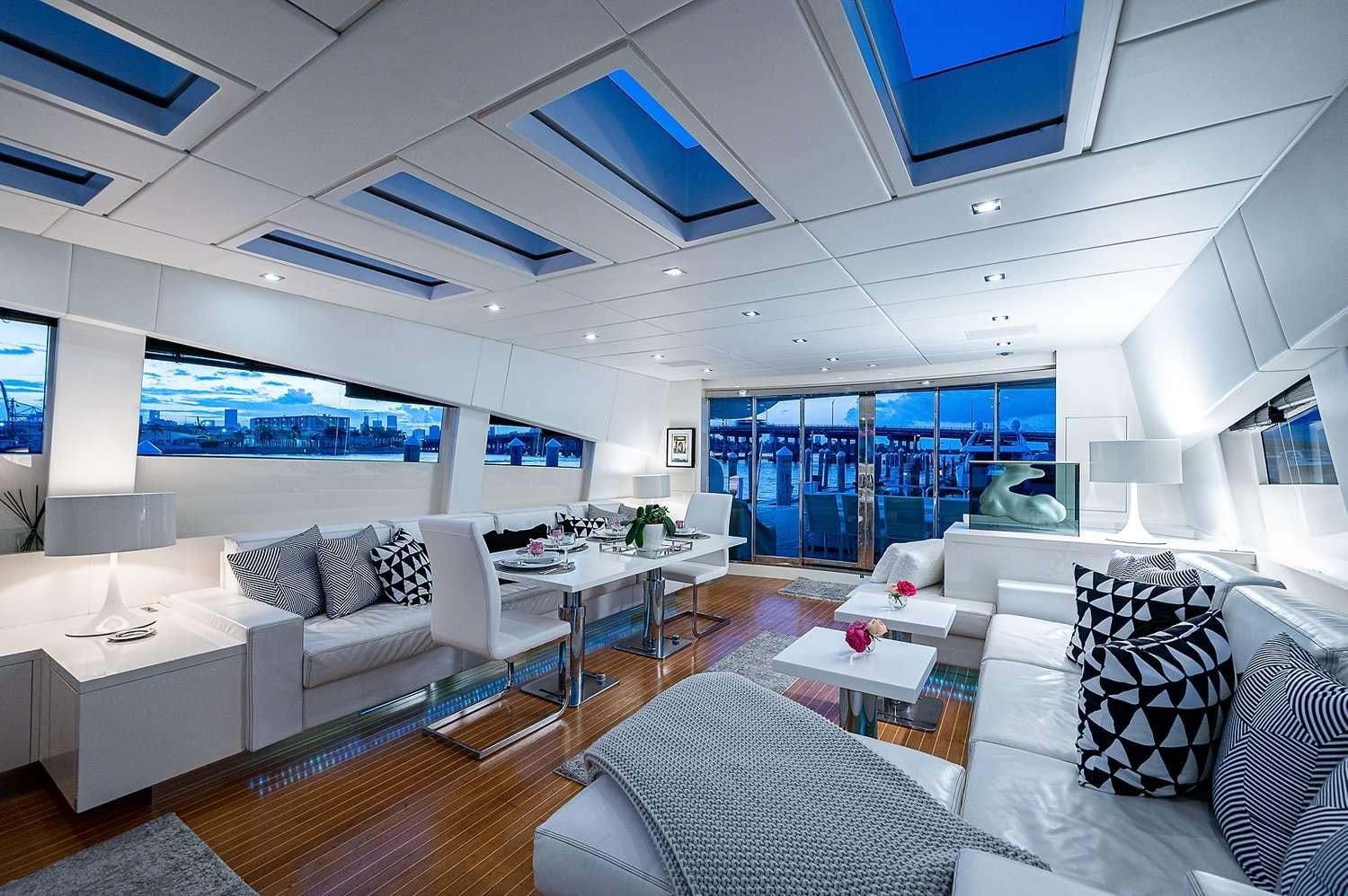 a living room with a large window aboard CASSINELLA Yacht for Charter