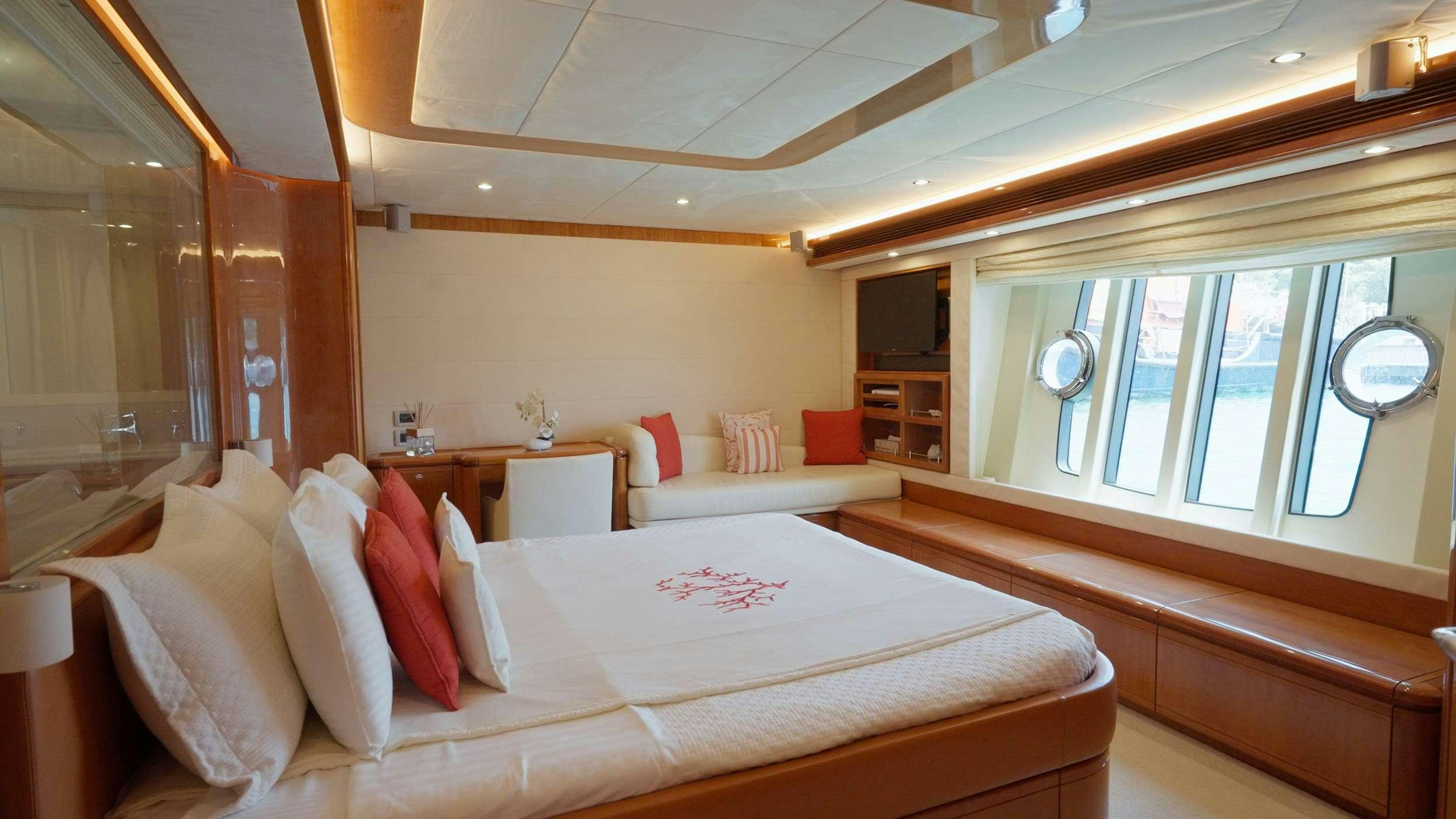 a room with a bed and a window aboard NATASSA ( EX LADY NATASA) Yacht for Charter