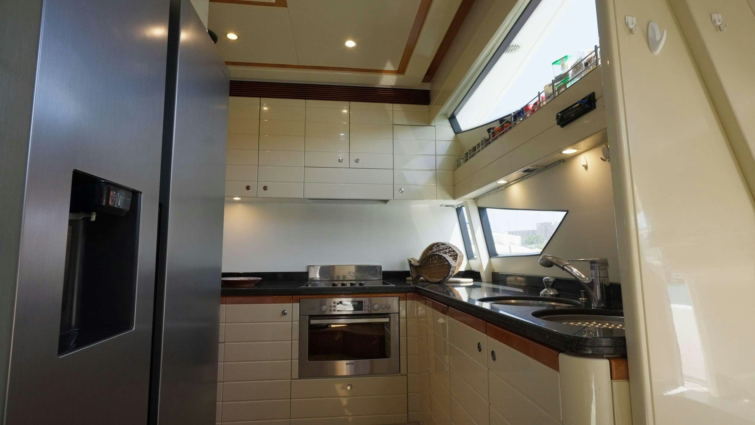 a kitchen with a black refrigerator aboard NATASSA ( EX LADY NATASA) Yacht for Charter